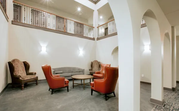 The central atrium's two-story sitting area with leather armchairs