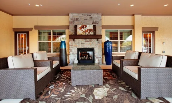 The covered veranda with arches, ceiling fans, and grilling stations